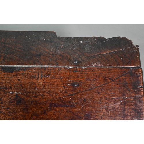 940 - An English oak Commonwealth period six plank coffer, the front fully carved with twin lunettes, 106 ... 