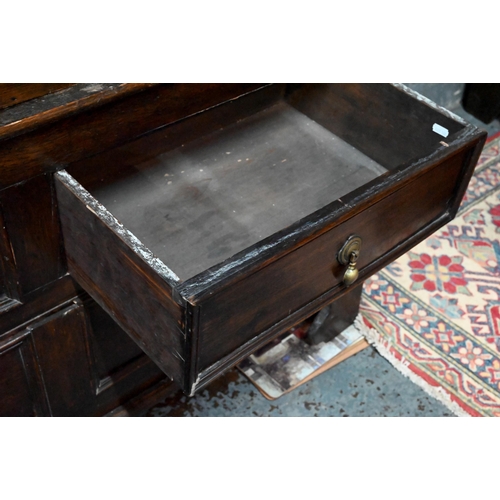 948 - An 18th century and later composed oak two section linen cupboard, the pair of joint framed triple p... 