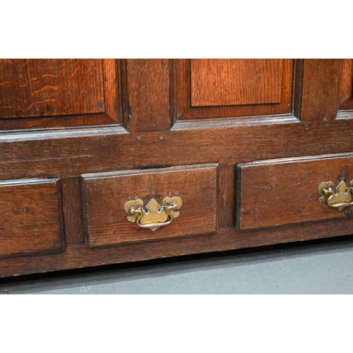 949 - An 18th century oak mule chest, the three plank top over four fielded arched panels and three drawer... 