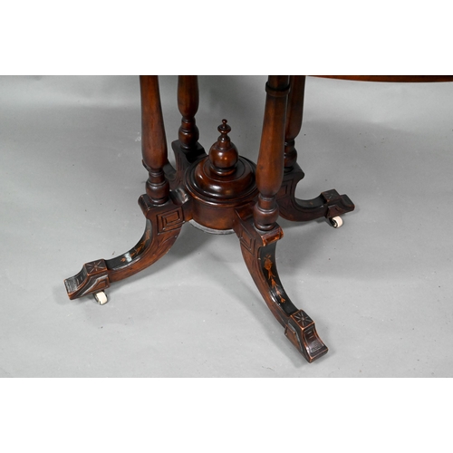 956 - A Victorian inlaid figured walnut centre table, the oval top raised on four to swept legs, on castor... 