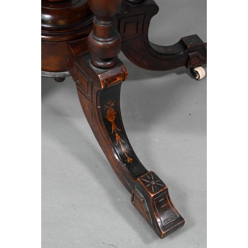 956 - A Victorian inlaid figured walnut centre table, the oval top raised on four to swept legs, on castor... 