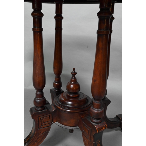 956 - A Victorian inlaid figured walnut centre table, the oval top raised on four to swept legs, on castor... 