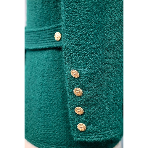 1280 - Chanel Boutique - A green wool jacket, double-breasted and fitted with six rows of double gilt-metal... 