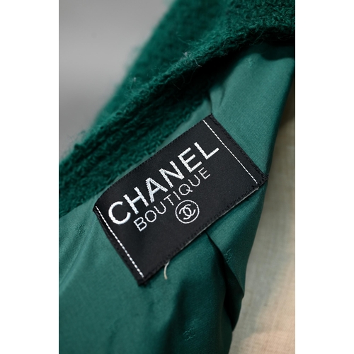 1280 - Chanel Boutique - A green wool jacket, double-breasted and fitted with six rows of double gilt-metal... 