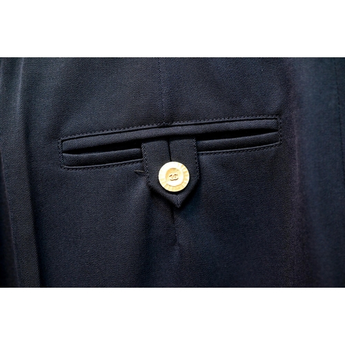 1282 - Chanel - A pair of navy trousers, with pleated front and gilt metal button detailing, fully lined, s... 