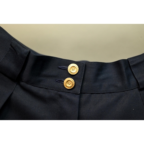 1282 - Chanel - A pair of navy trousers, with pleated front and gilt metal button detailing, fully lined, s... 