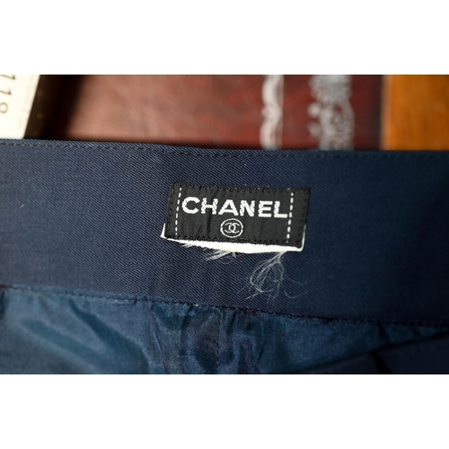 1282 - Chanel - A pair of navy trousers, with pleated front and gilt metal button detailing, fully lined, s... 