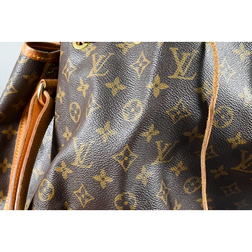 1283 - Louis Vuitton - A duffle bag with drawstring and single strap handle c/w dust bag