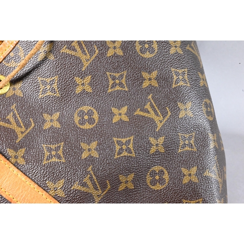 1283 - Louis Vuitton - A duffle bag with drawstring and single strap handle c/w dust bag