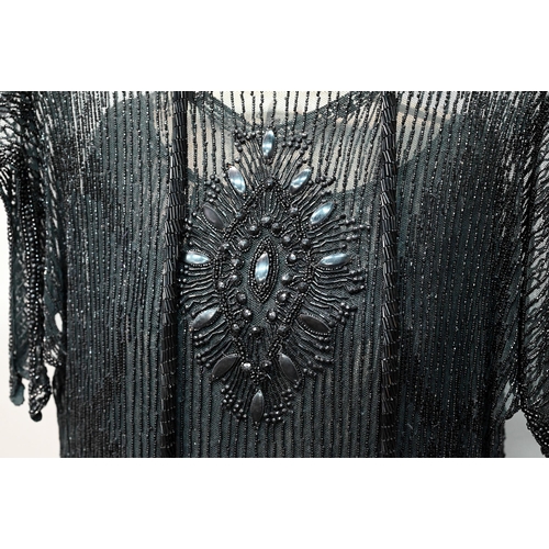 1287 - Two 1920s black 'flapper' dresses, heavily beaded and embellished on fine net, one with beaded cord ... 