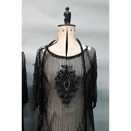 1287 - Two 1920s black 'flapper' dresses, heavily beaded and embellished on fine net, one with beaded cord ... 