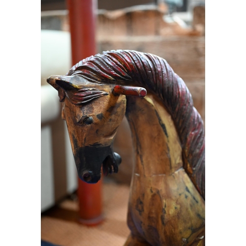 1150A - A carved wood rocking horse with leather saddle, 80 cm high