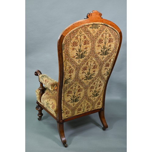 850A - A Victorian walnut framed open armchair with carved crest, deep buttoned back and stuff-over seats, ... 