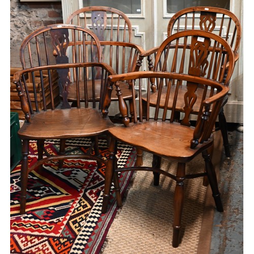 Four 19th century well-matched harlequin yew and elm low splat-back Windsor armchairs with crinoline stretchers (4)