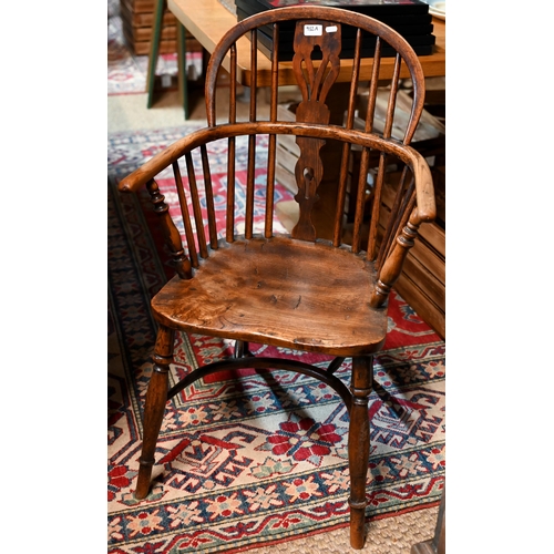 932A - A yew Windsor armchair with shaped splat and crinoline stretcher