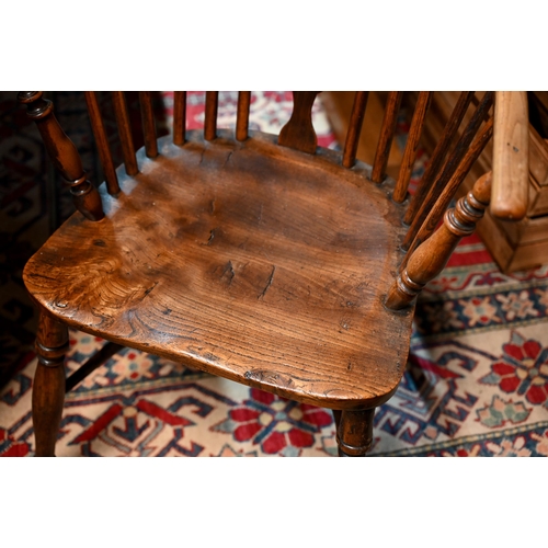 932A - A yew Windsor armchair with shaped splat and crinoline stretcher