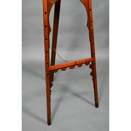 874A - An Edwardian pictue easel in the Liberty manner, with shaped frame, strut back and decorative 'spind... 