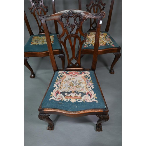 859A - A set of mahogany Chippendale-style dining chairs with ball and claw feet and sabre back legs, with ... 