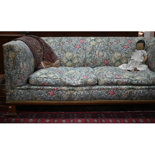 922 - An Arts & Crafts period Liberty style sofa, well upholstered in piped William Morris fabric, wit... 