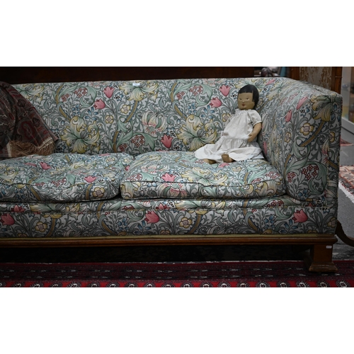 922 - An Arts & Crafts period Liberty style sofa, well upholstered in piped William Morris fabric, wit... 