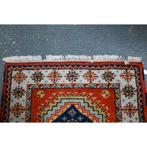 1218 - A contemporary Indo-Persian Kazak runner, burnt orange ground with five alternating lozenge design, ... 