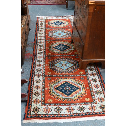 1218 - A contemporary Indo-Persian Kazak runner, burnt orange ground with five alternating lozenge design, ... 