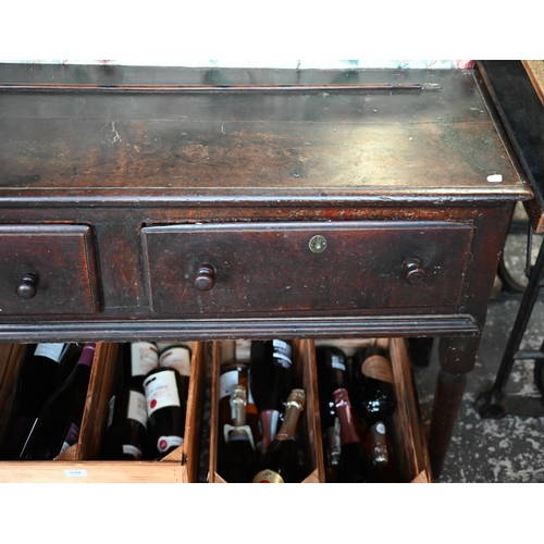 901 - An 18th century oak three drawer low dresser, very dark surface finish, raised on three turned front... 