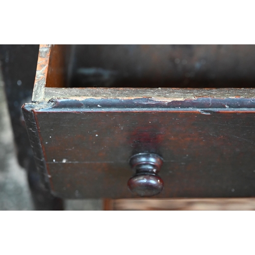 901 - An 18th century oak three drawer low dresser, very dark surface finish, raised on three turned front... 