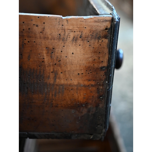 901 - An 18th century oak three drawer low dresser, very dark surface finish, raised on three turned front... 