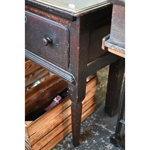 901 - An 18th century oak three drawer low dresser, very dark surface finish, raised on three turned front... 