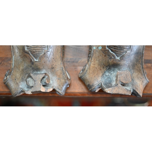 977 - A pair of 19th century Continental carved wood furniture brackets, worked with lions, 33 cm high