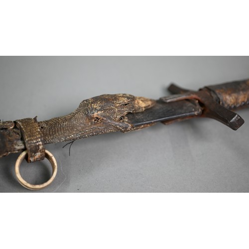 1109 - An African Hausa tribal sword, the 53 cm blade with iron crosspiece guard and hide-bound wooden grip... 