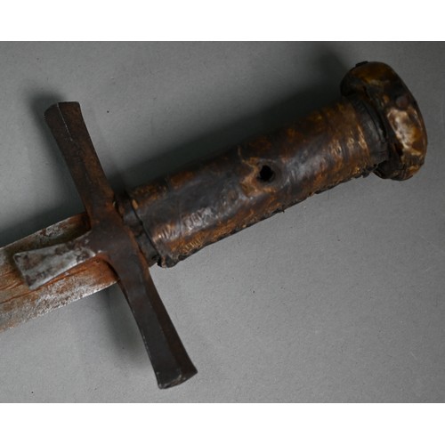 1109 - An African Hausa tribal sword, the 53 cm blade with iron crosspiece guard and hide-bound wooden grip... 