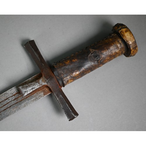 1109 - An African Hausa tribal sword, the 53 cm blade with iron crosspiece guard and hide-bound wooden grip... 