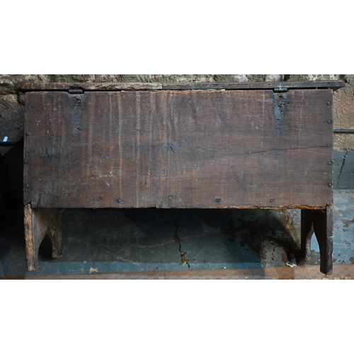 939 - A 17th century oak six plank coffer, with iron staple lock and key, the relief carved front centred ... 