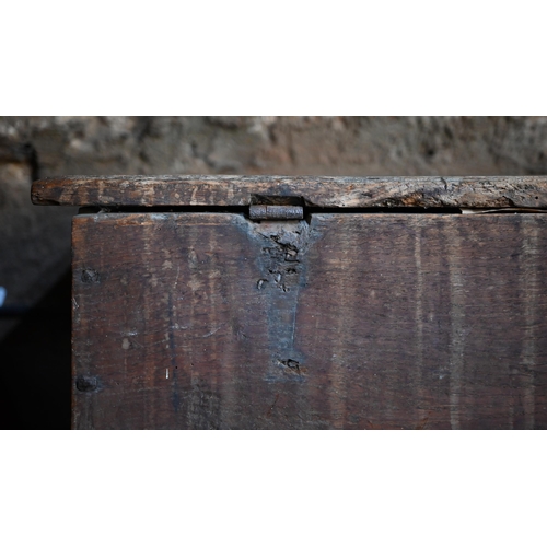 939 - A 17th century oak six plank coffer, with iron staple lock and key, the relief carved front centred ... 