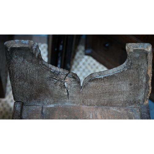 939 - A 17th century oak six plank coffer, with iron staple lock and key, the relief carved front centred ... 