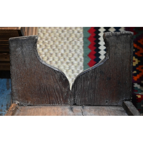 939 - A 17th century oak six plank coffer, with iron staple lock and key, the relief carved front centred ... 