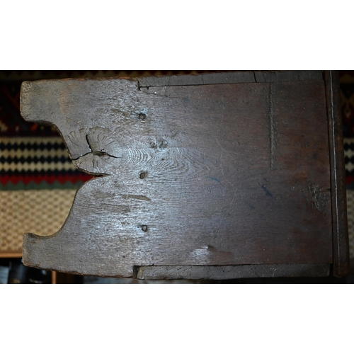 939 - A 17th century oak six plank coffer, with iron staple lock and key, the relief carved front centred ... 