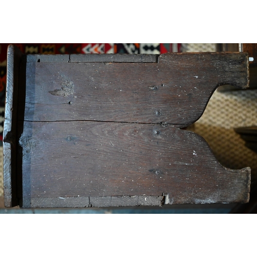 939 - A 17th century oak six plank coffer, with iron staple lock and key, the relief carved front centred ... 