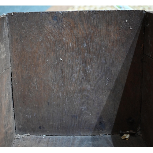 939 - A 17th century oak six plank coffer, with iron staple lock and key, the relief carved front centred ... 