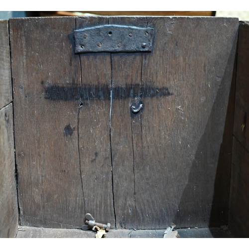 939 - A 17th century oak six plank coffer, with iron staple lock and key, the relief carved front centred ... 