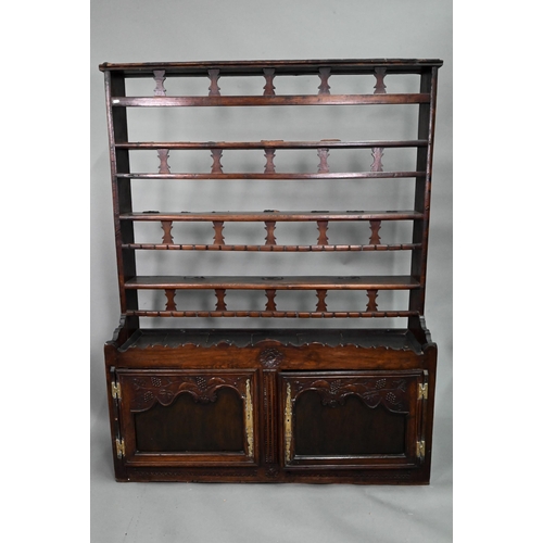 11 - An antique provincial French oak high dresser, the three tier rack with pierced balustrades, over tw... 