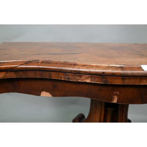 19 - A Victorian walnut card table, the fold over serpentine top with baize lining, raise on moulded clus... 