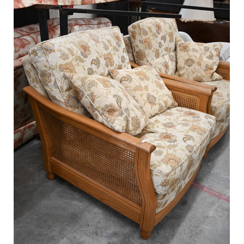 45 - An Ercol ash and woven cane bergere three piece suite, two seater sofa and pair of armchairs, uphols... 