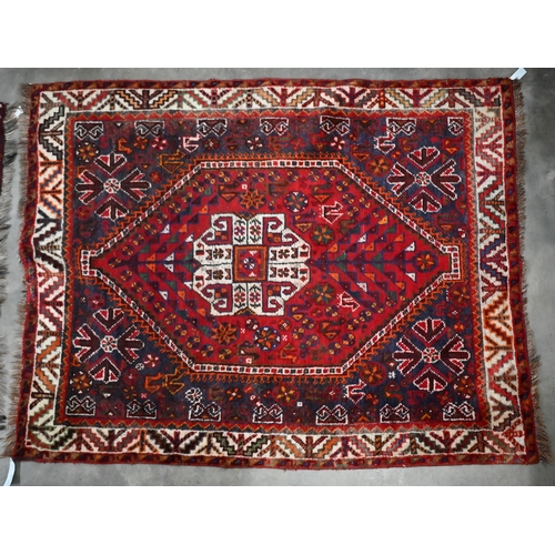 103 - A Persian Shiraz rug, ivory medallion on red ground with stylised animals and floral designs, 150 x ... 