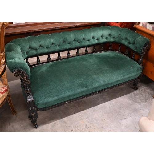Late Victorian/Aesthetic settee, the ebonised spindled open frame with incised decoration and green buttoned fabric upholstery, 160 x 70 x 70 cm