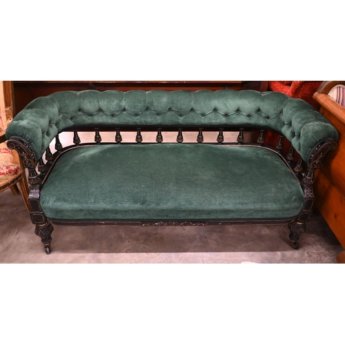 110 - Late Victorian/Aesthetic settee, the ebonised spindled open frame with incised decoration and green ... 