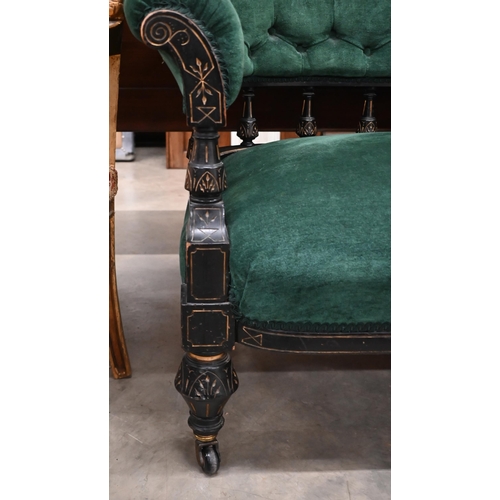 110 - Late Victorian/Aesthetic settee, the ebonised spindled open frame with incised decoration and green ... 