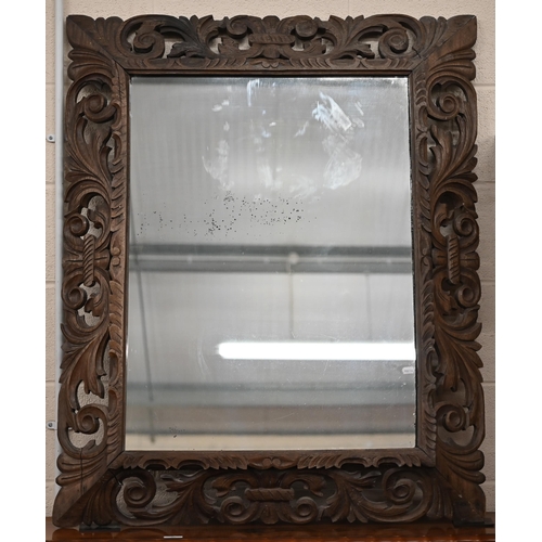 114 - A foliate carved and pierced hardwood framed 'Florentine' mirror, 90 x 114 cm